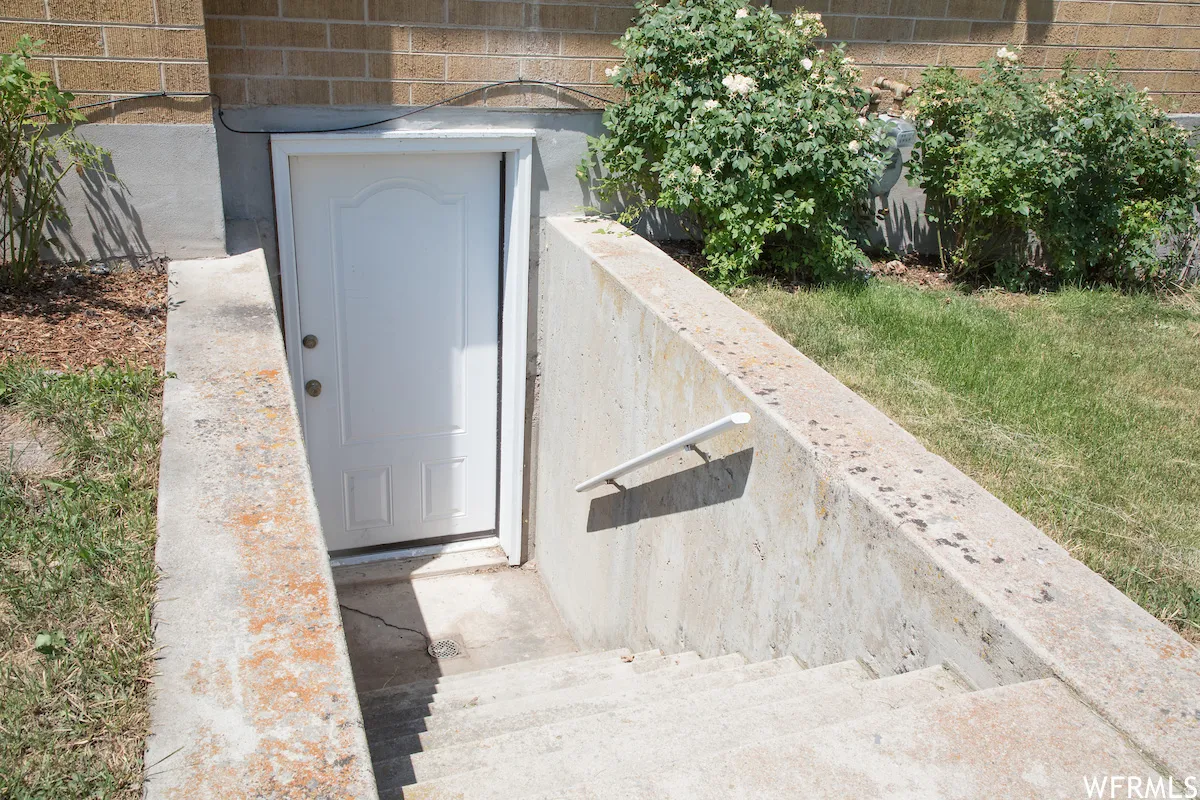 Concrete stairwell leading to a white exterior door