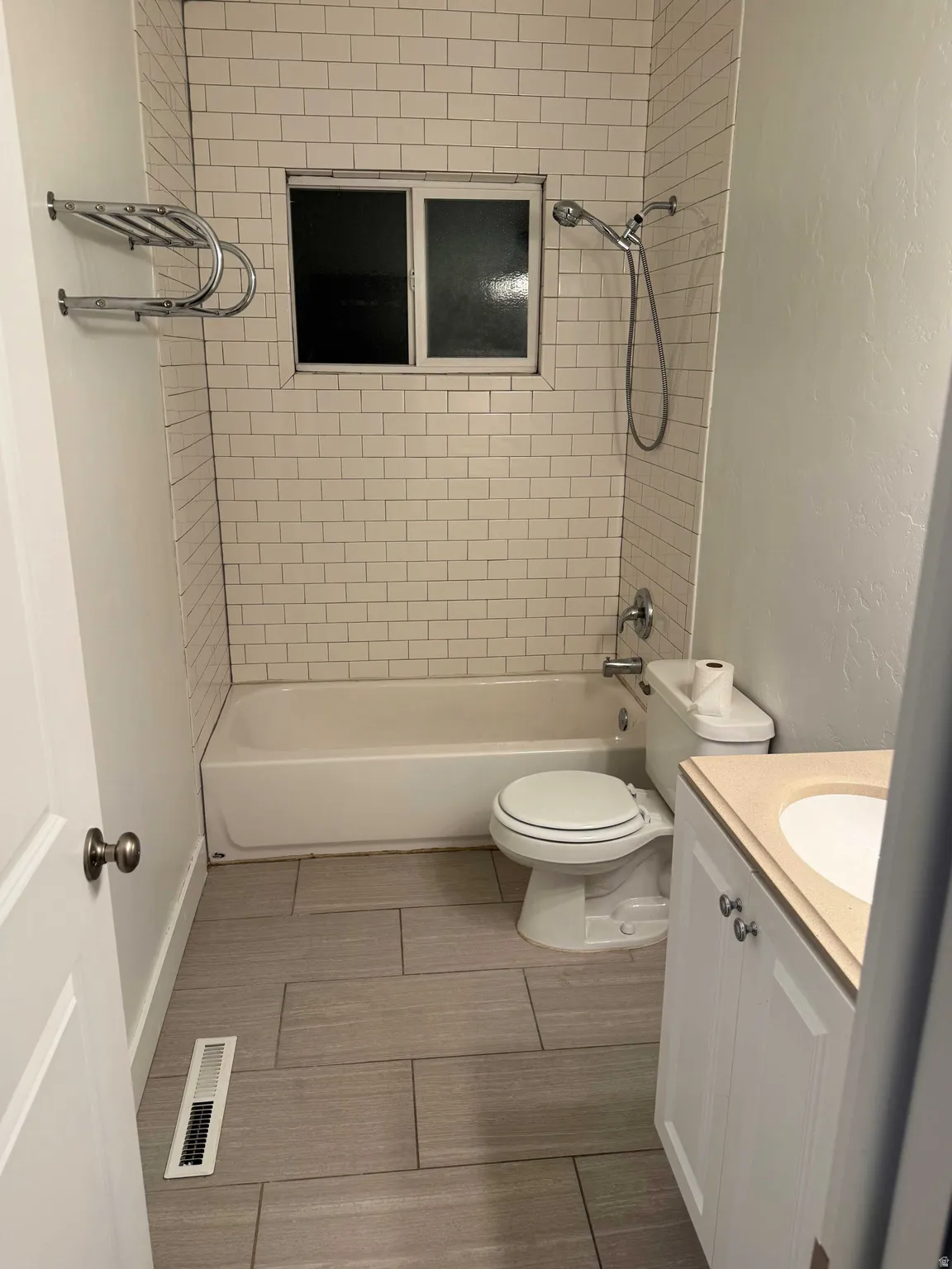 White subway tile shower surround with integrated window