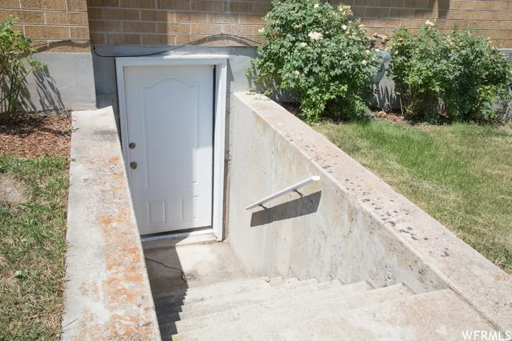 Concrete stairwell leading to a white exterior door