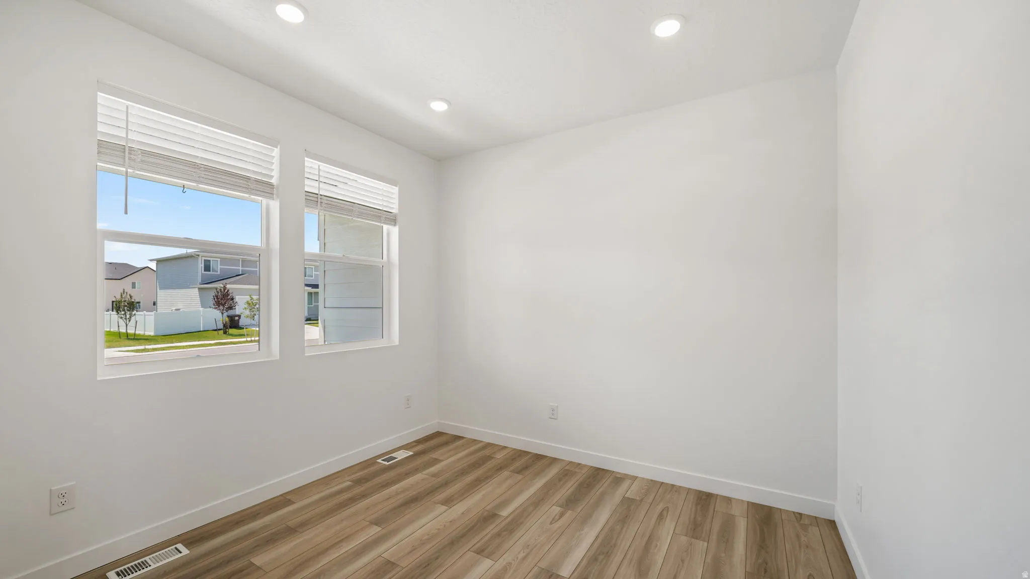 Wood-finish flooring, recessed lighting, and dual pane windows