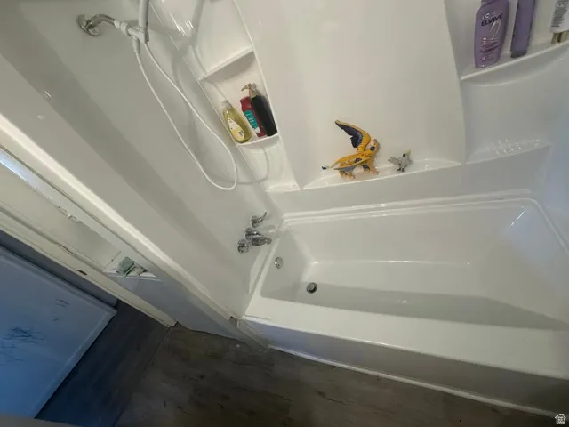 White fiberglass tub and shower combination with chrome fixtures