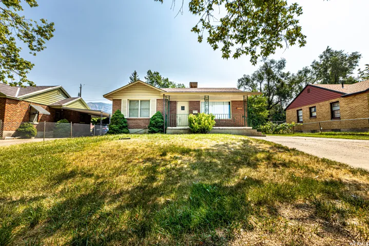 Brick exterior with white siding accents and a covered front porch
