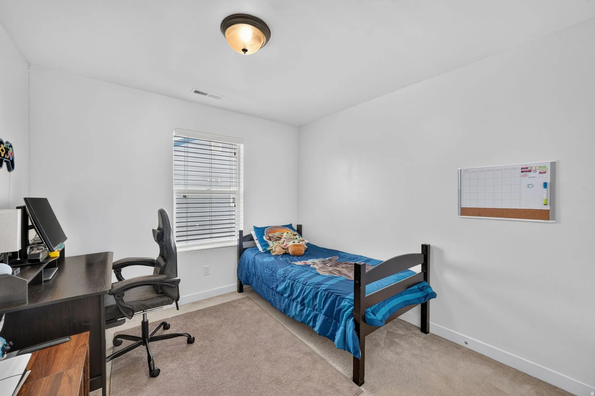 Recessed window with blinds, overhead flush mount light fixture, and carpeted flooring