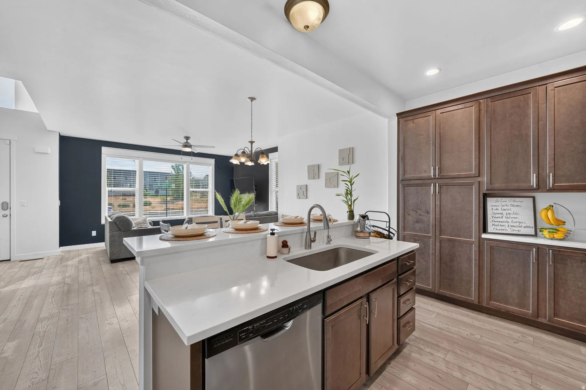 Kitchen island with an undermount sink and stainless steel dishwasher