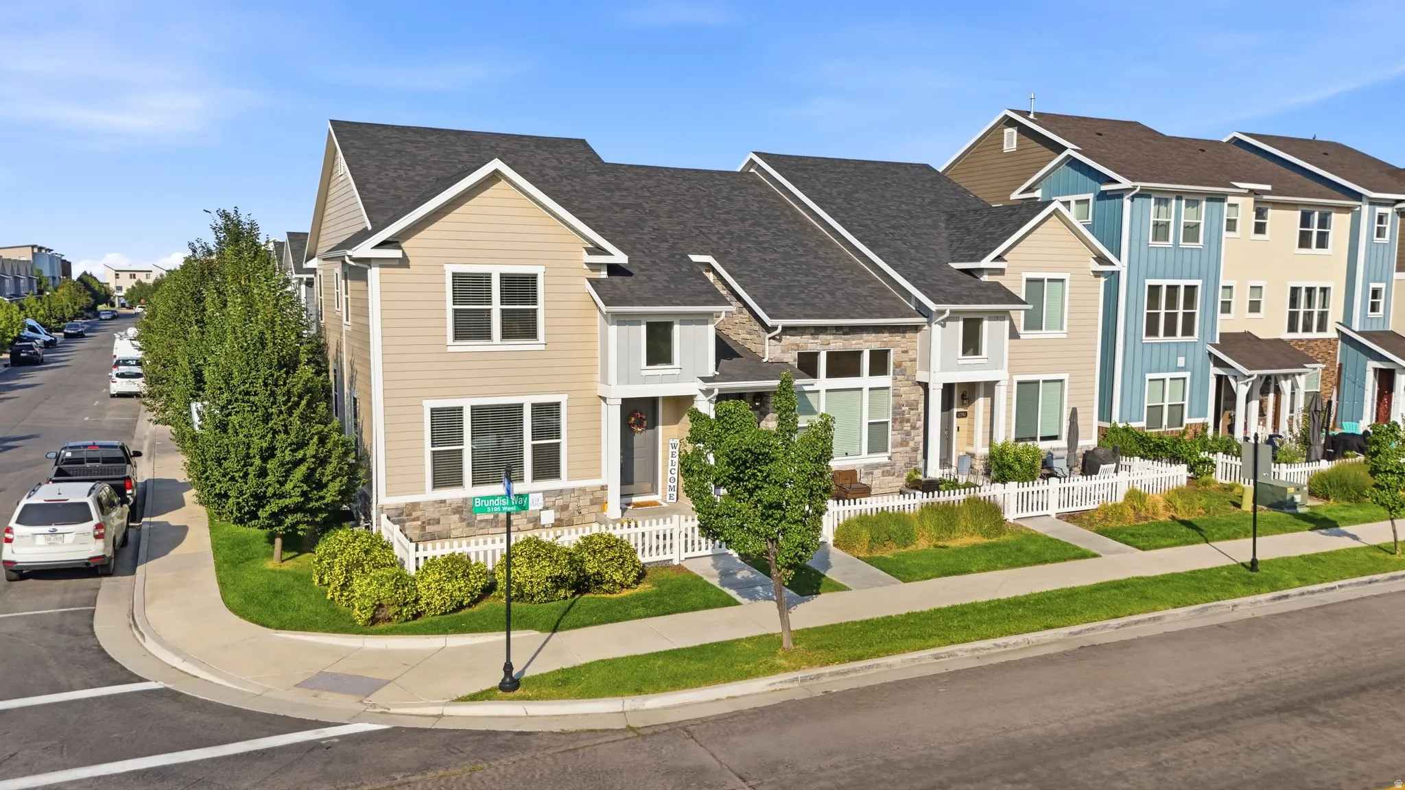 Two-story exterior with light siding and stone accents