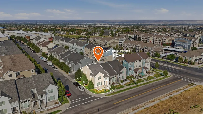 Corner lot property with a light-toned exterior, dark roof, and manicured landscaping