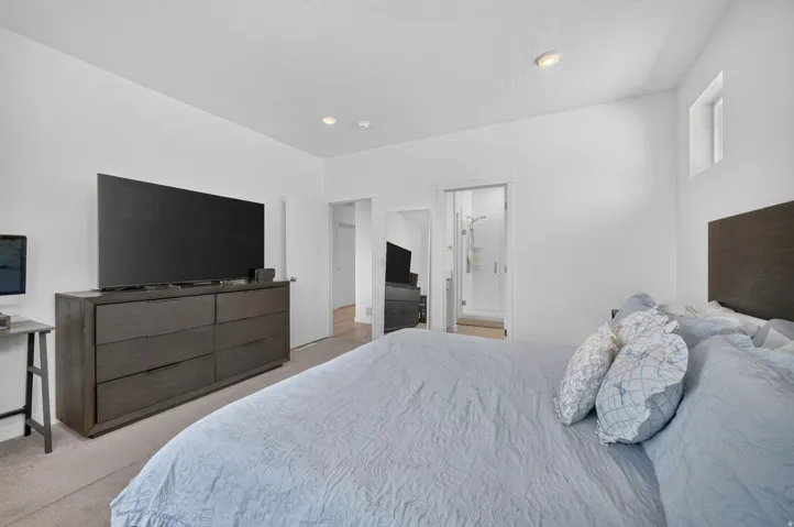 Recessed lighting, high ceilings, and a high window