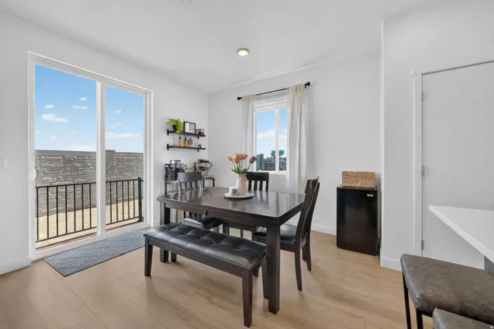 Wood-finish flooring throughout, with white walls and a recessed light fixture
