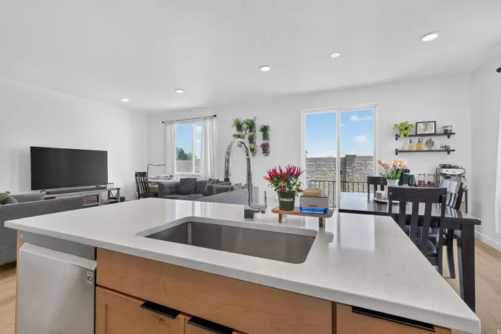 Kitchen island with a built-in stainless steel sink and gooseneck faucet