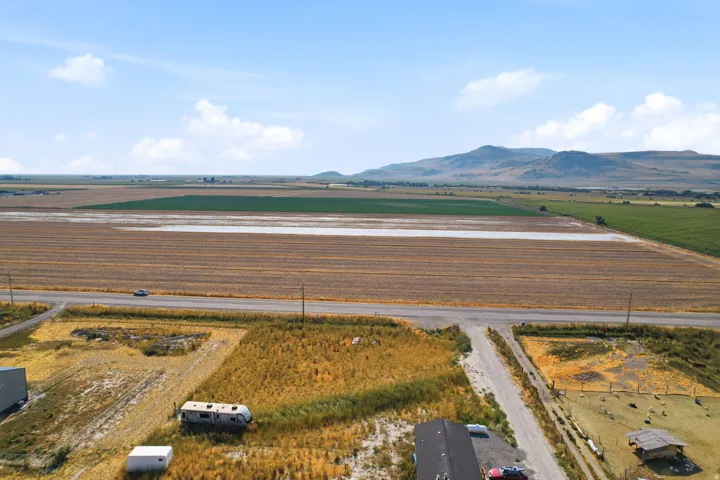 Rural setting with expansive agricultural fields and distant mountains