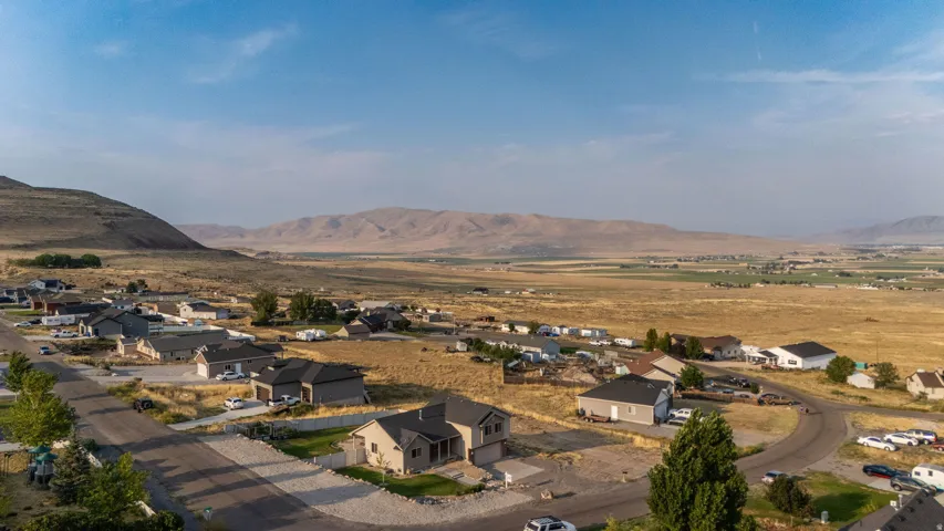 Residential neighborhood with paved streets and distant mountain ranges