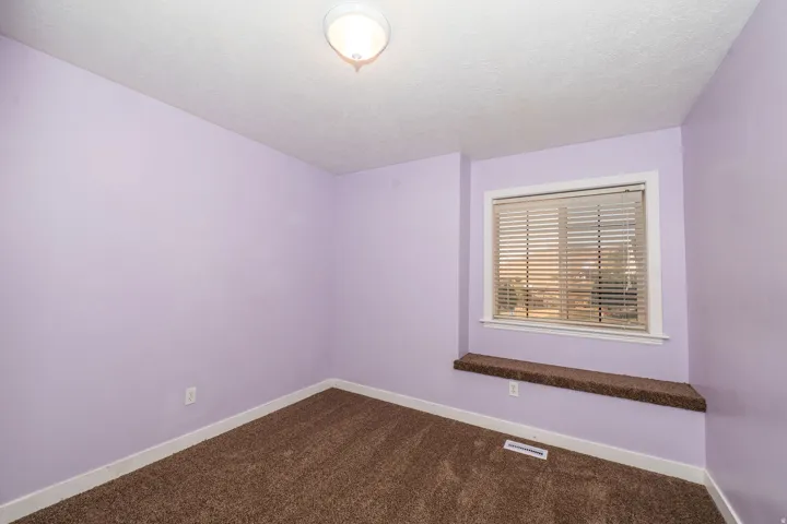 Recessed window with blinds and a built-in window seat