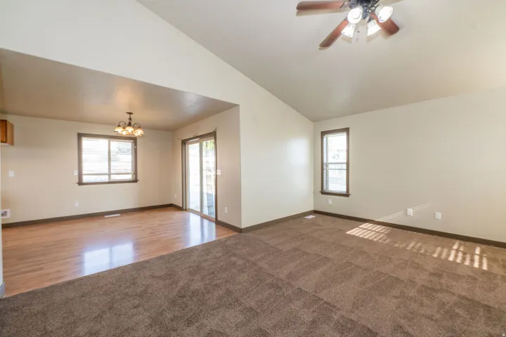Vaulted ceiling, ceiling fan, wood-finish flooring, sliding glass door, recessed lighting