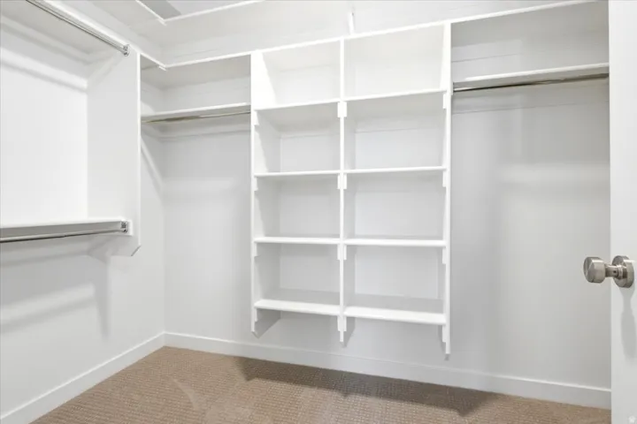 Built-in closet system with multiple shelving units and hanging rods