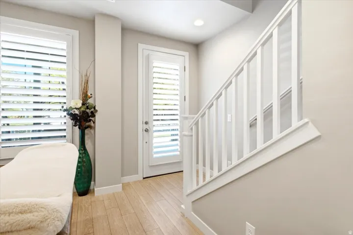 Wood-finish flooring complemented by white trim and plantation shutters