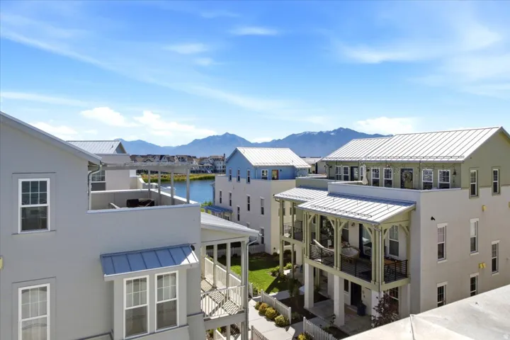 Multiple properties featuring standing seam metal roofs, private balconies, and waterfront access