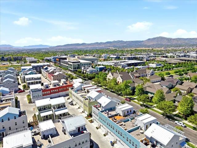 Expansive neighborhood with diverse architectural styles, featuring established green spaces and a mountain backdrop
