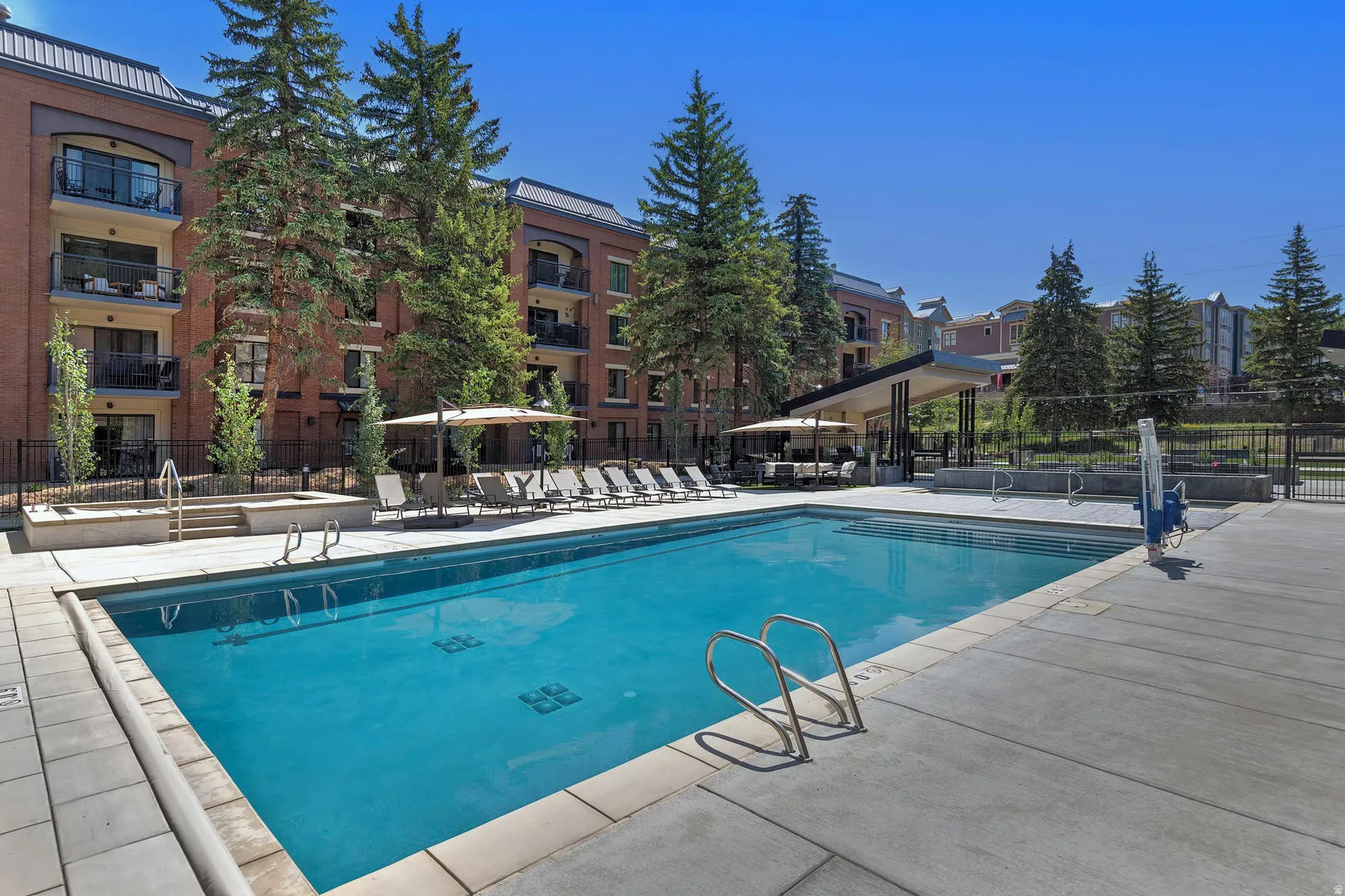 Outdoor swimming pool surrounded by concrete decking