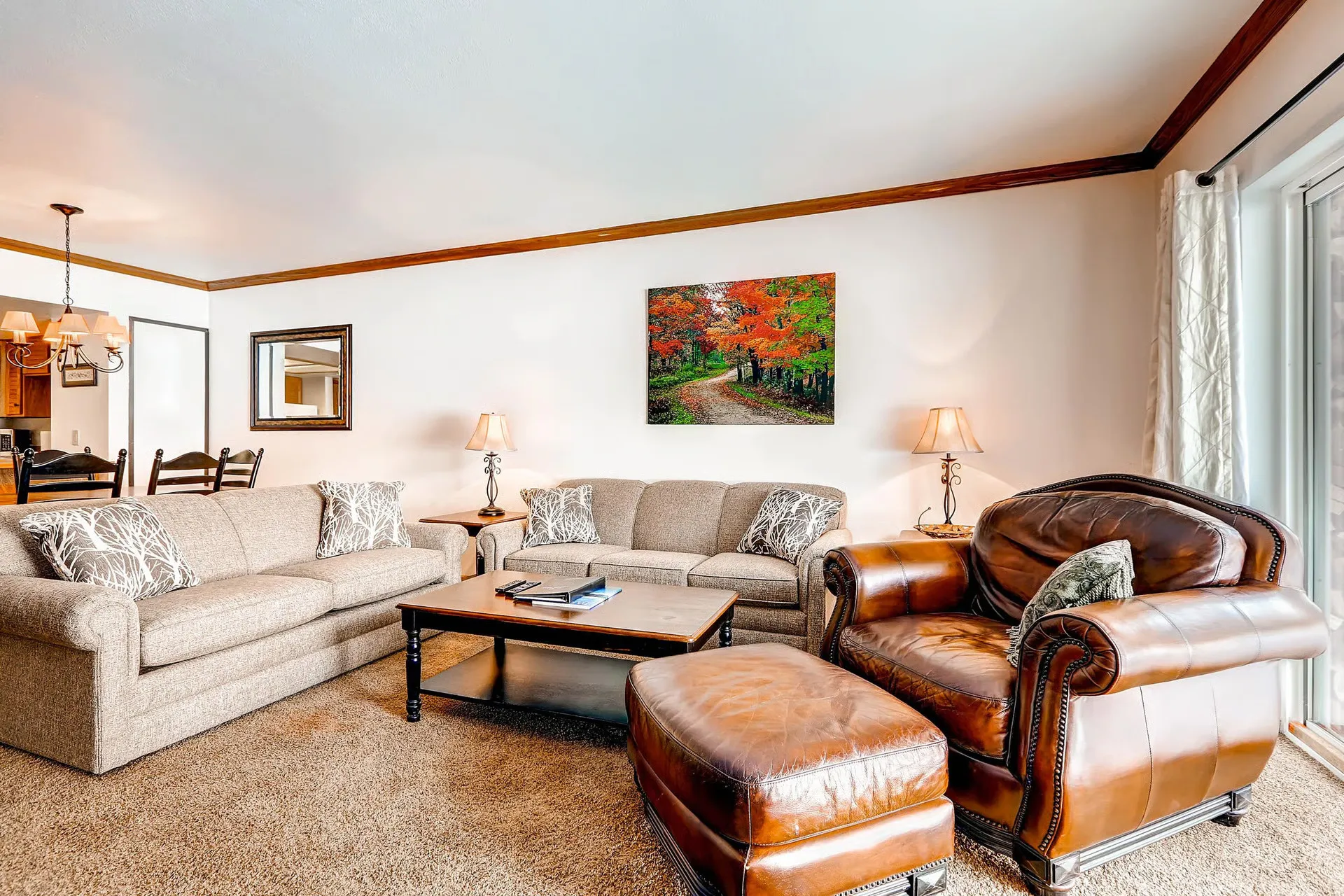 Living area featuring wall-to-wall carpeting and a glass sliding door