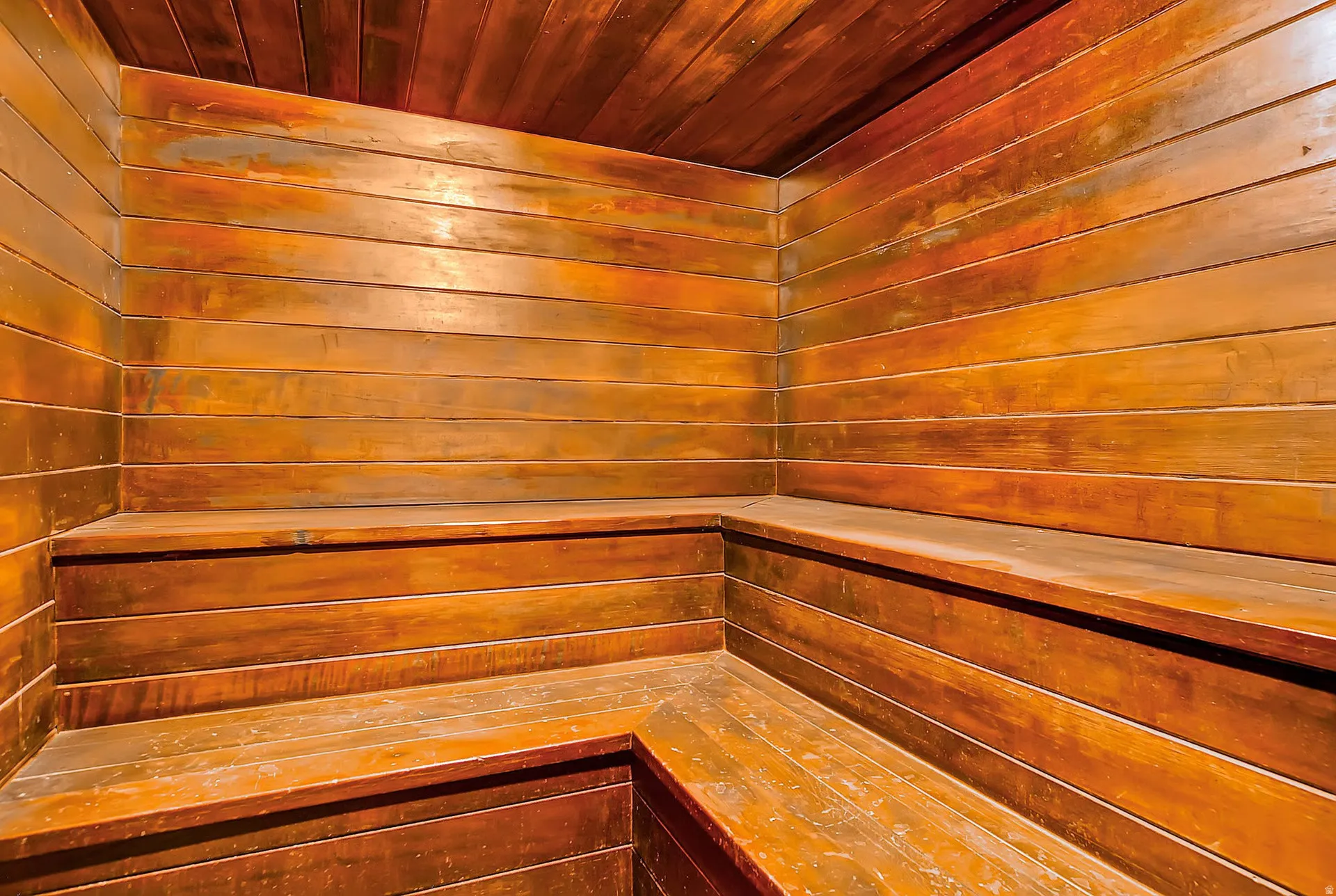 Wood-paneled room featuring tiered bench seating