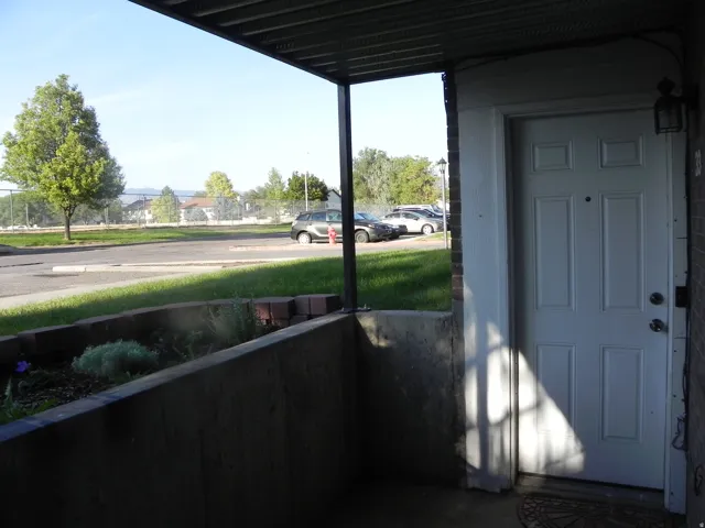Covered entry with concrete flooring and a paneled entry door