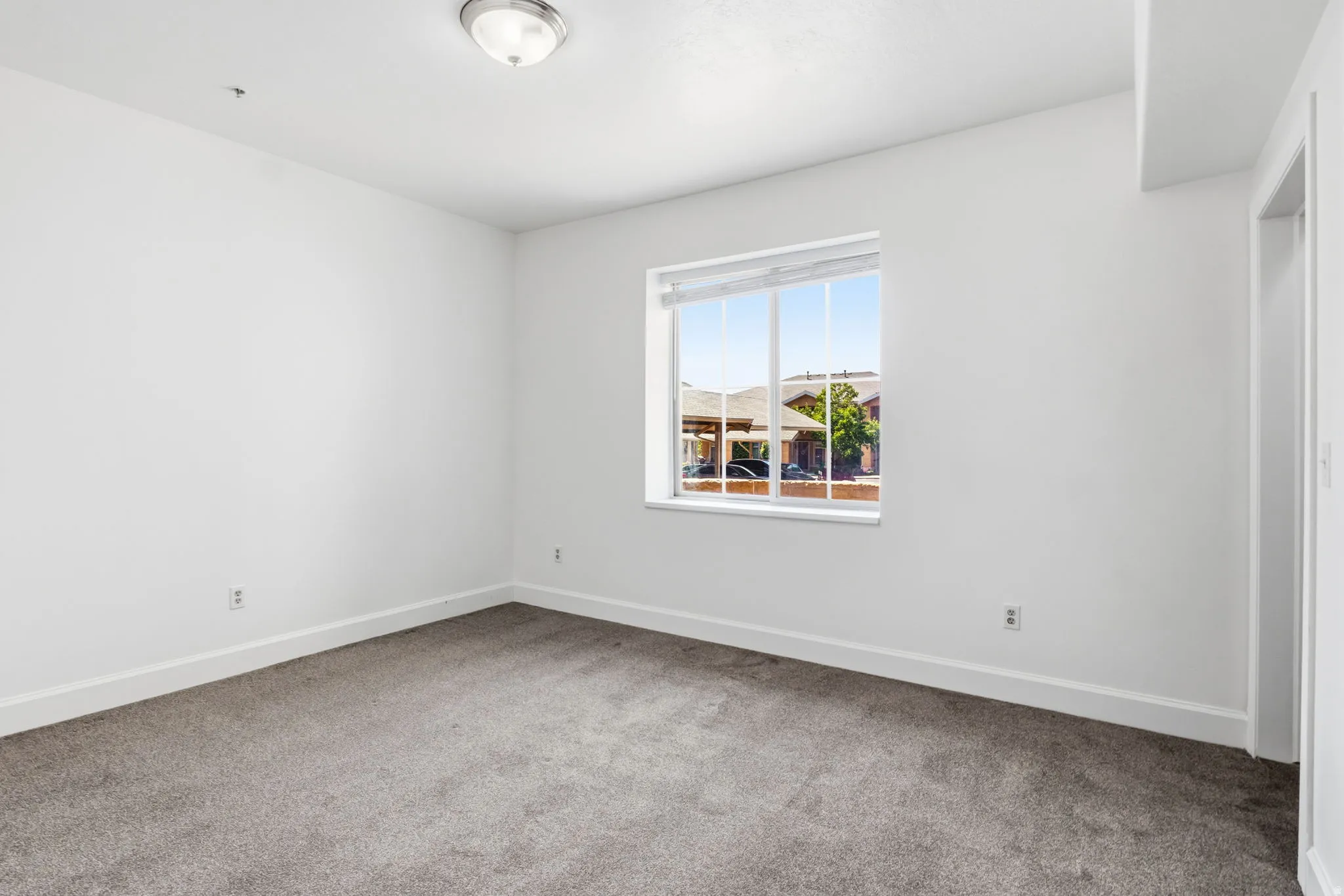 Neutral-toned walls complement the gray carpeting