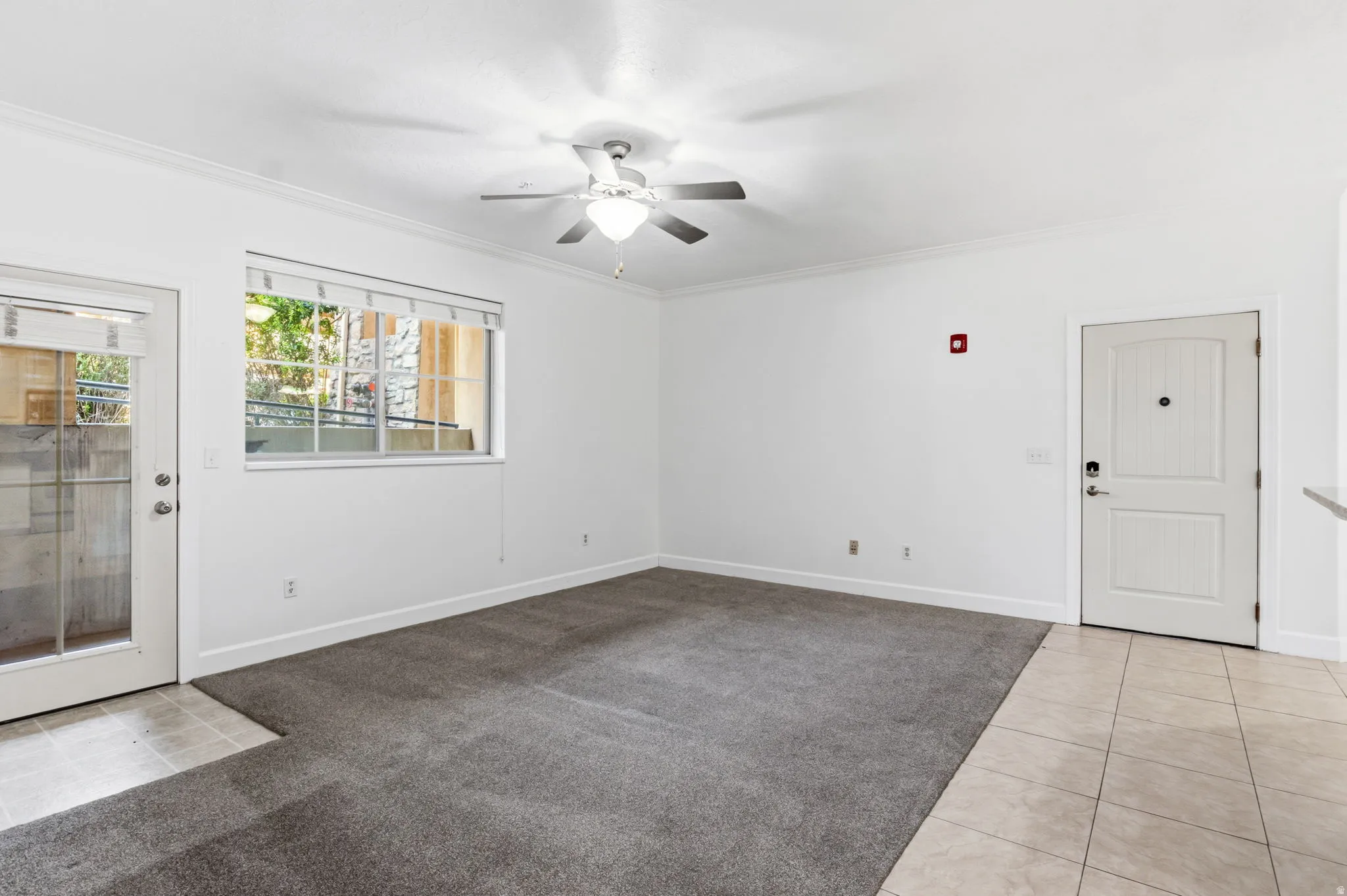 Recessed lighting, ceiling fan, crown molding, white paneled door, and tile flooring