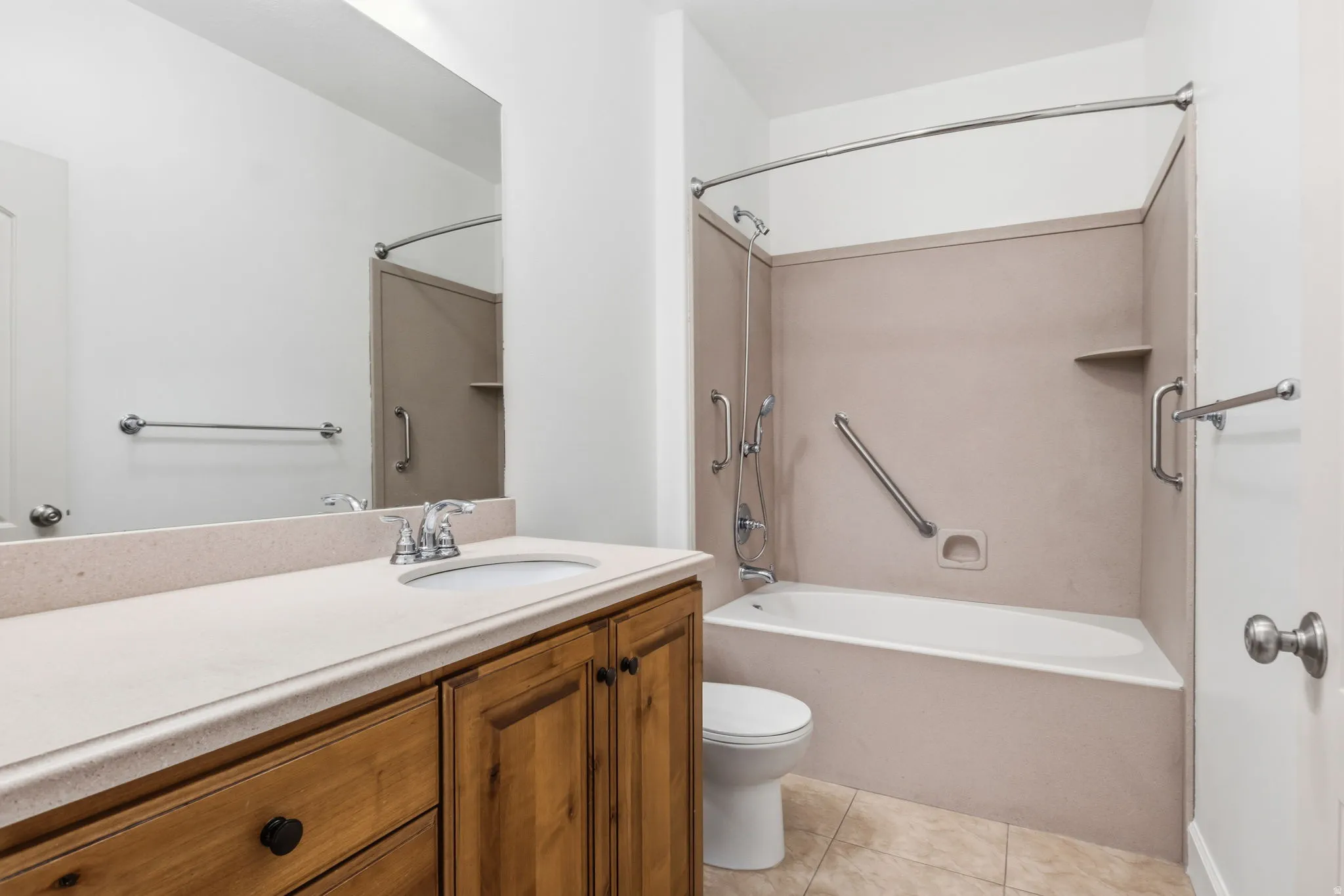 Vanity with integrated sink, chrome faucet, and wood-finish cabinetry