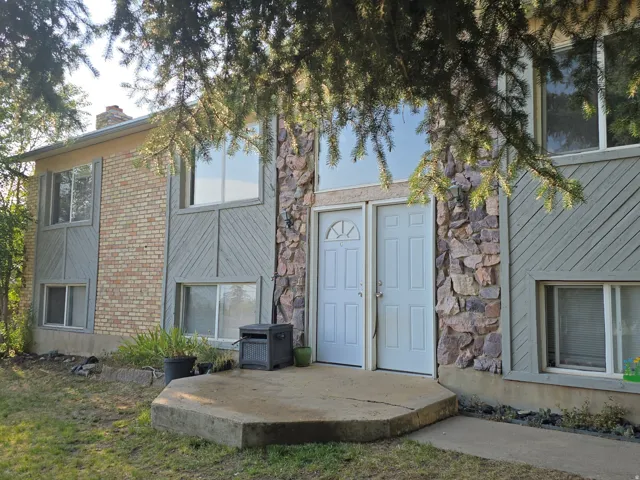 Brick and stone veneer exterior with a concrete entry pad