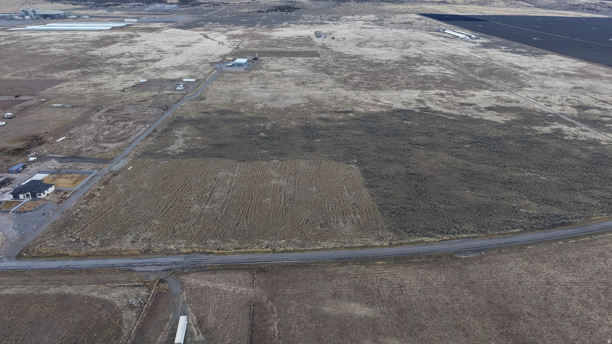 Expansive undeveloped land with a paved road frontage