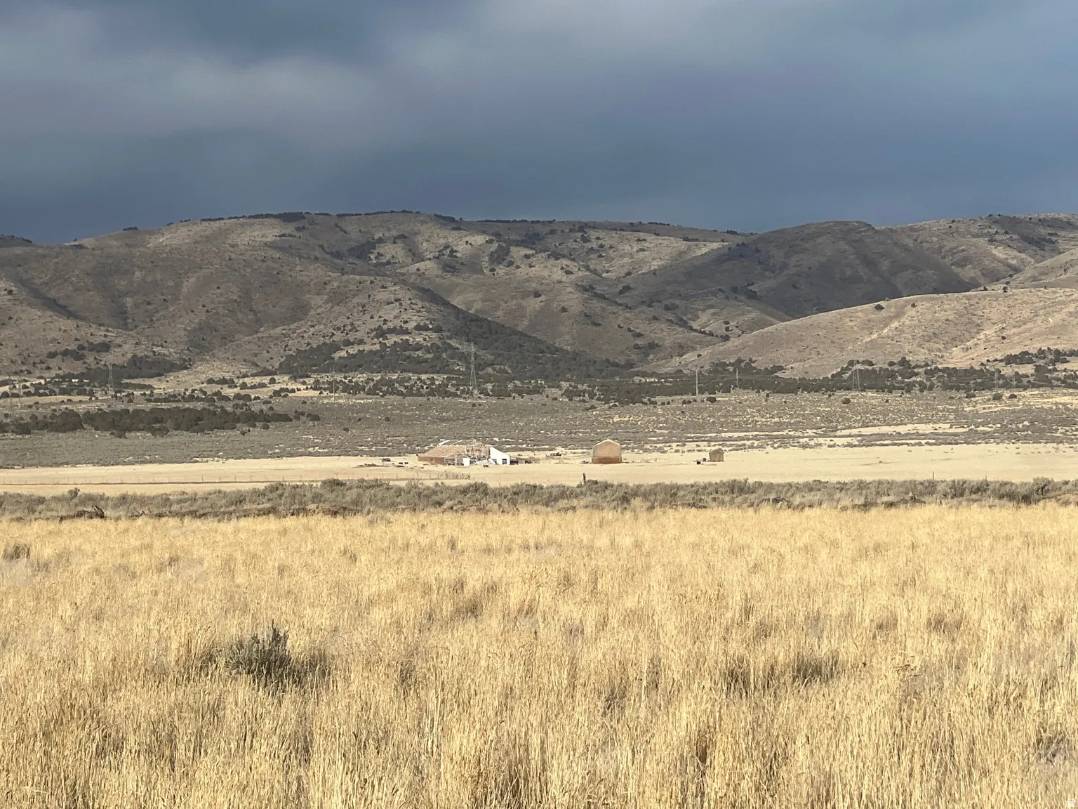 Expansive open terrain with natural vegetation and distant mountain ranges