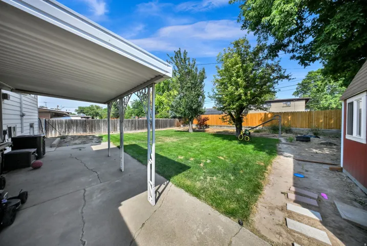Covered concrete patio with decorative metal supports
