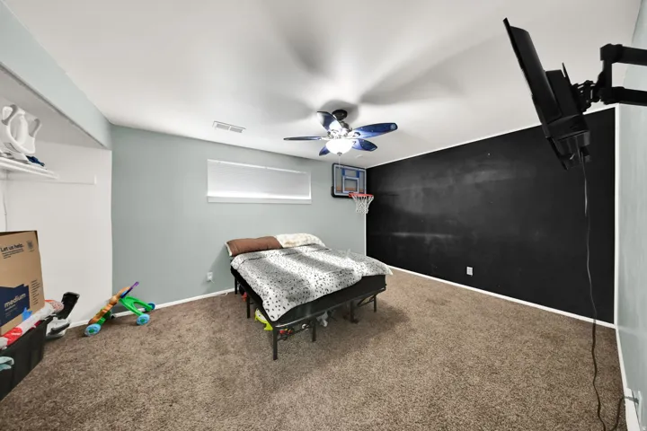 Wall-mounted lighting fixture, ceiling fan, and carpeted flooring
