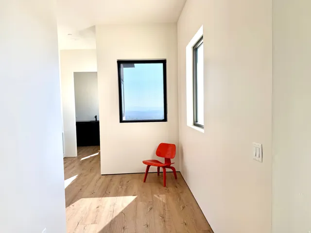 Wood-finish flooring with crisp white walls and black-framed windows