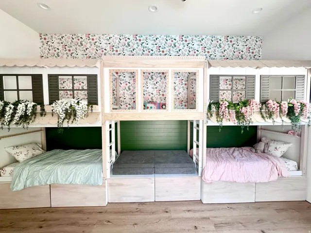 Built-in bunk beds with decorative window shutters and scalloped trim