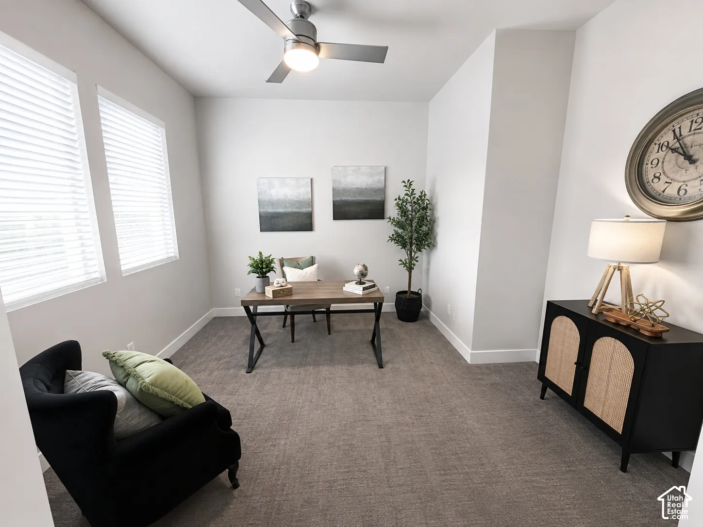 Recessed lighting, ceiling fan, two windows with blinds, and neutral carpeting