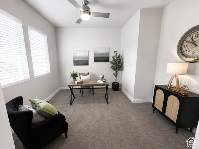 Recessed lighting, ceiling fan, two windows with blinds, and neutral carpeting