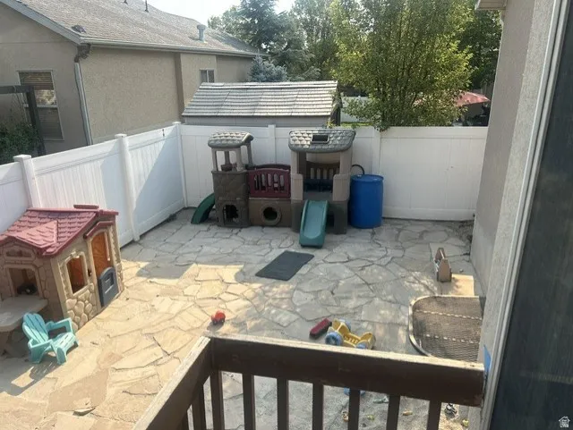 Private outdoor space featuring flagstone paving and perimeter fencing.
