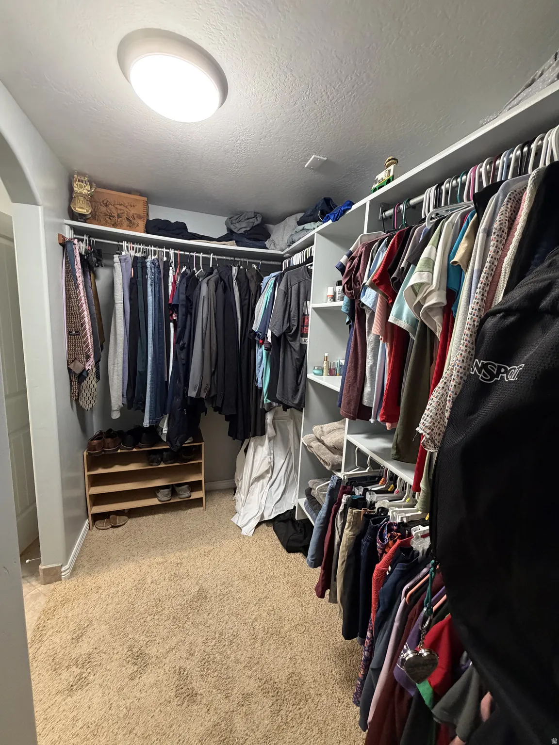 Primary suite #2 closet. Spacious walk-in closet with dual clothing rods, abundant hanging storage, and built-in shelving