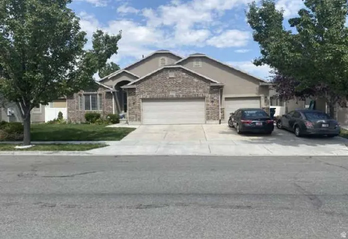 Stucco and brick exterior with a prominent arched entry. Extra parking space.