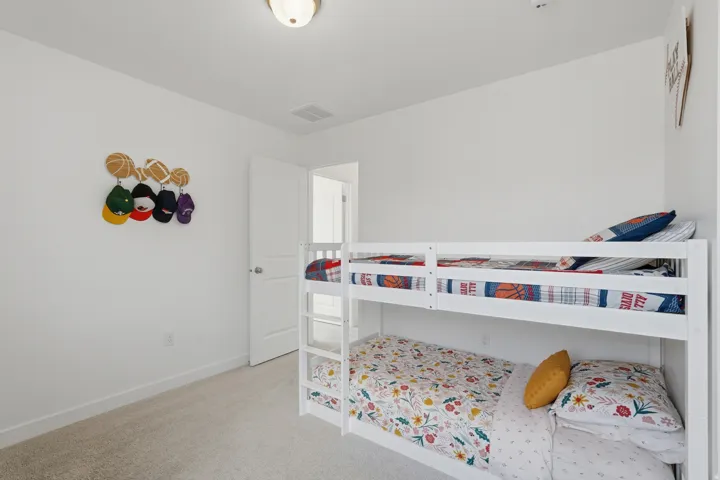 Recessed ceiling light, light gray carpeting, white walls, white interior door, and white trim