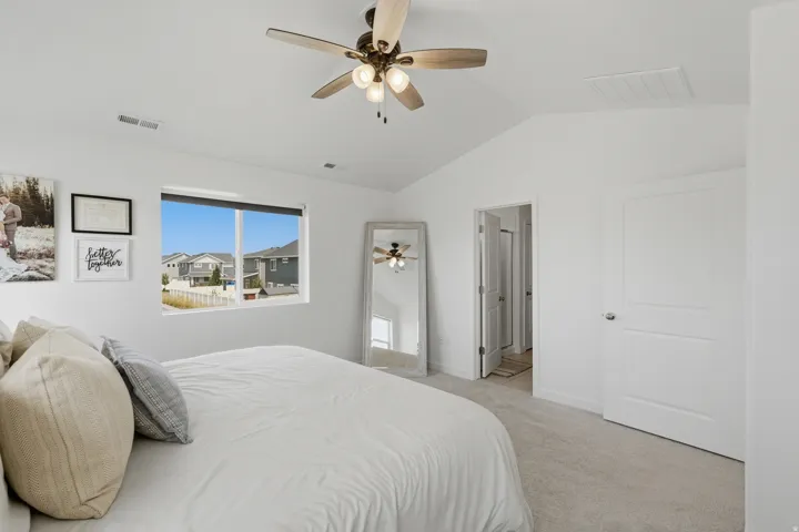 Angled ceiling with a modern ceiling fan and recessed lighting