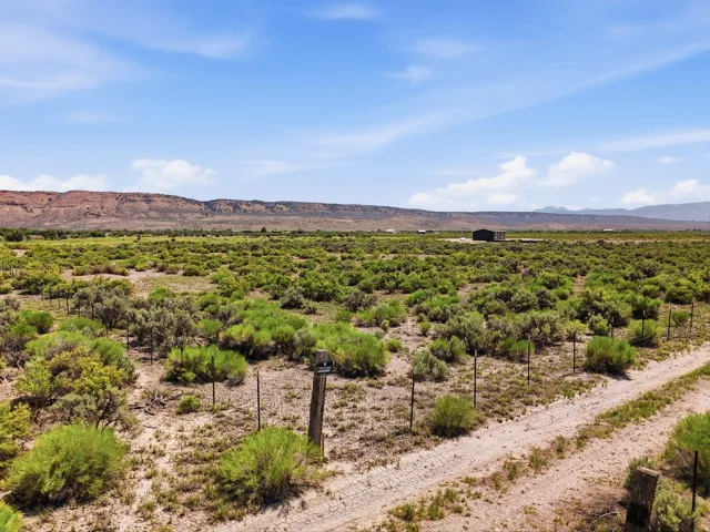 Expansive open terrain with natural vegetation and distant mountain ranges