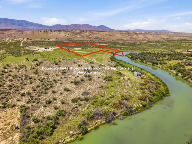 Expansive parcel featuring river frontage, a clear river, and distant mountains