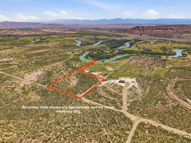 Expansive undeveloped land with a distant river and mountain backdrop