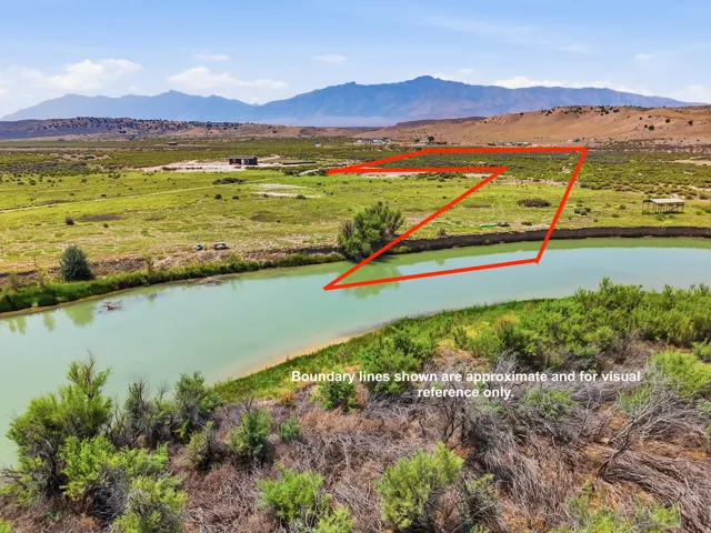 Expansive green acreage with a prominent water feature