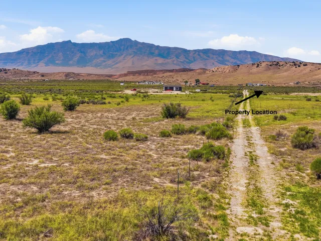 Expansive landscape with a dirt road and distant mountain range