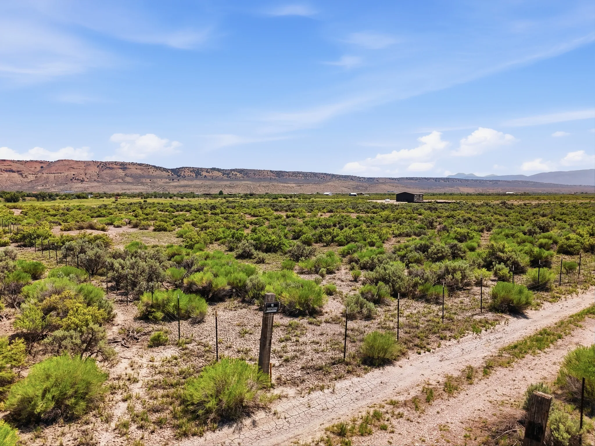 Expansive open terrain with natural vegetation and distant mountain ranges