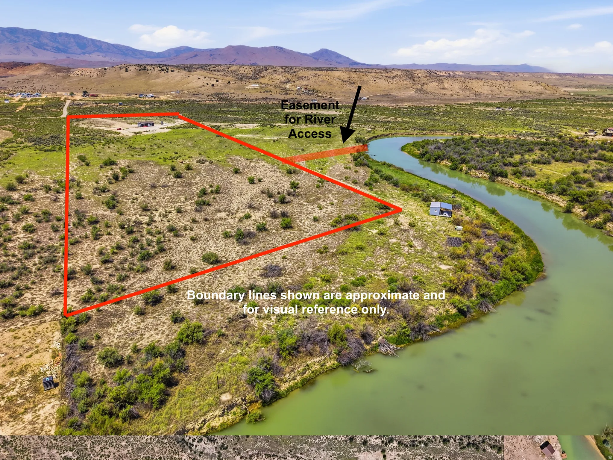 Expansive land parcel featuring natural vegetation and river frontage