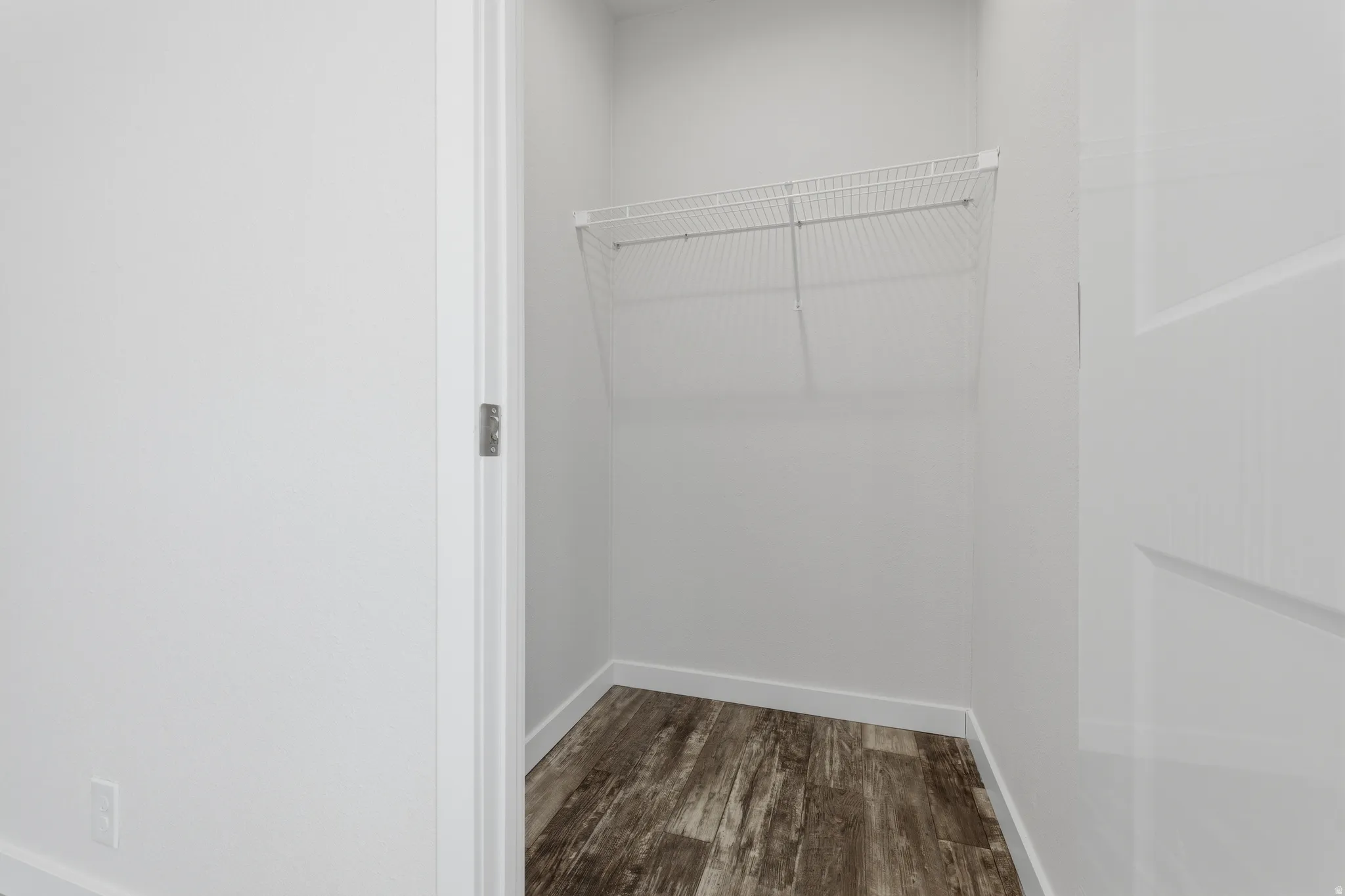 Closet with wire shelving and wood-finish flooring